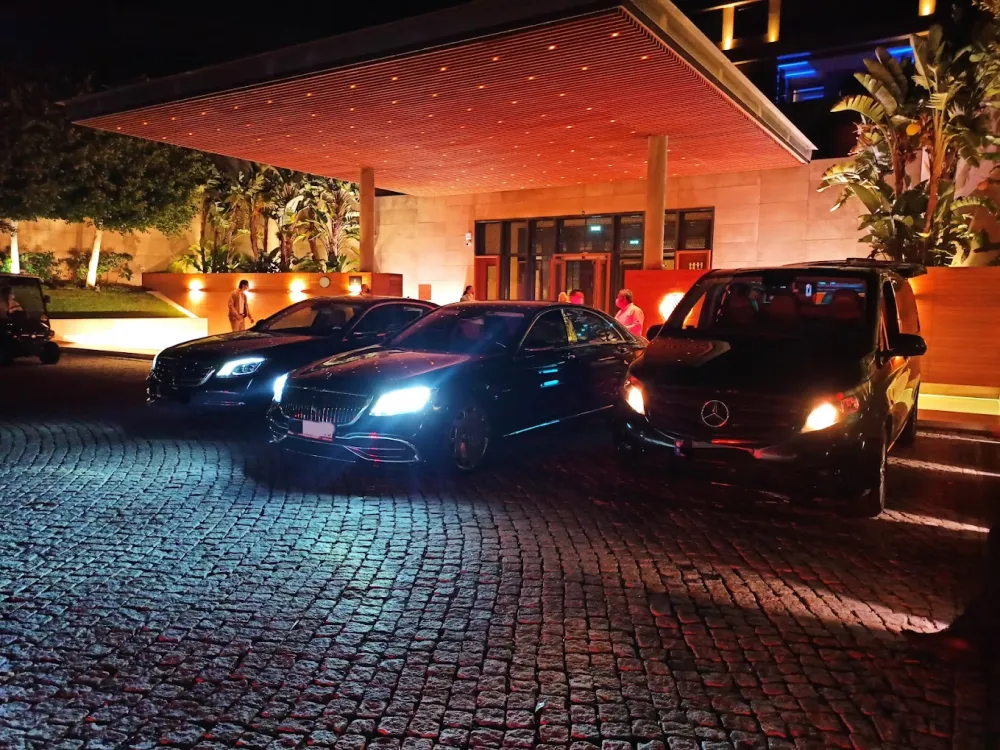 Luxury Mercedes vehicles in front of D Maris Bay hotel in the evening - Night transfer and private driver service in Ma